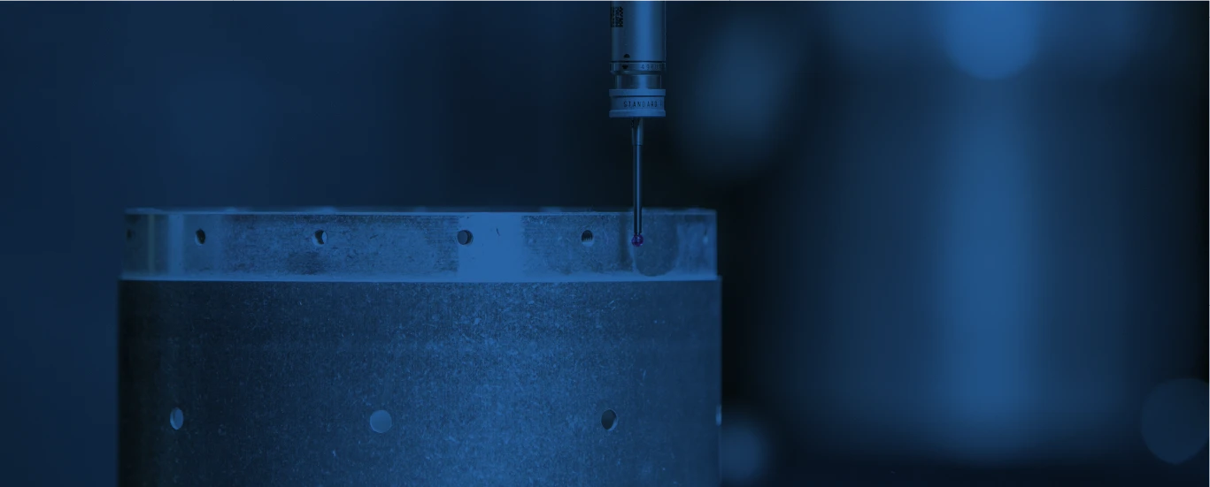 Coordinate measuring machine inspecting a precision machined metal component for quality assurance.