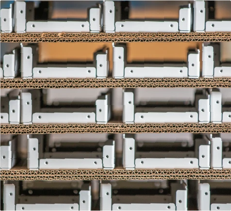 Organized inventory of precision manufactured metal components prepared for assembly or shipment.